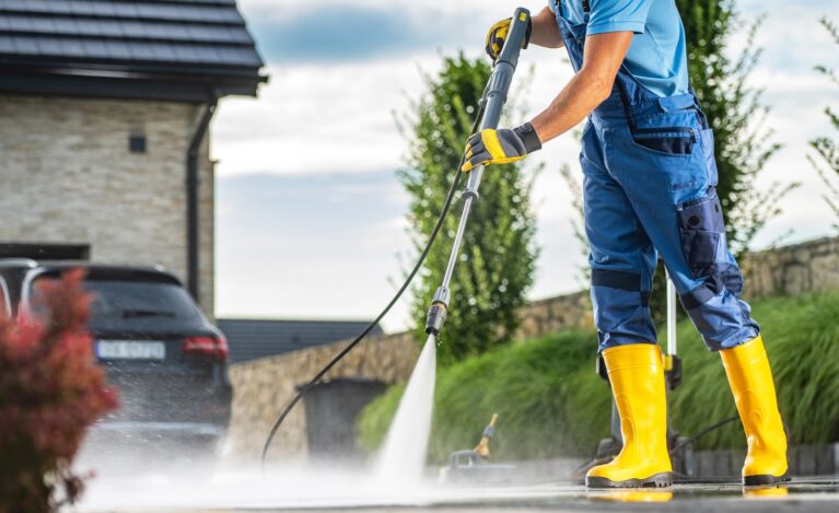 Caucasian,Homeowner,Using,Powerful,Pressure,Washer,To,Clean,Dirty,Driveway